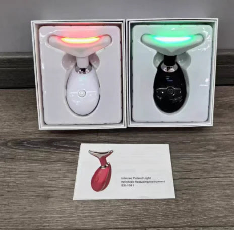 Two electronic devices in boxes with a business card on a wooden surface