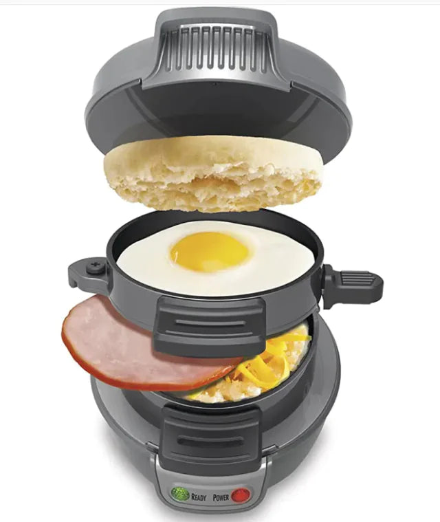 Breakfast sandwich maker with English muffin, egg, and ham on a white background
