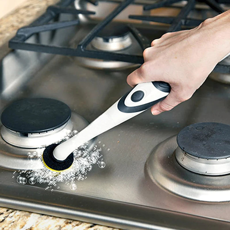 Person cleaning a gas stove with a scrubber