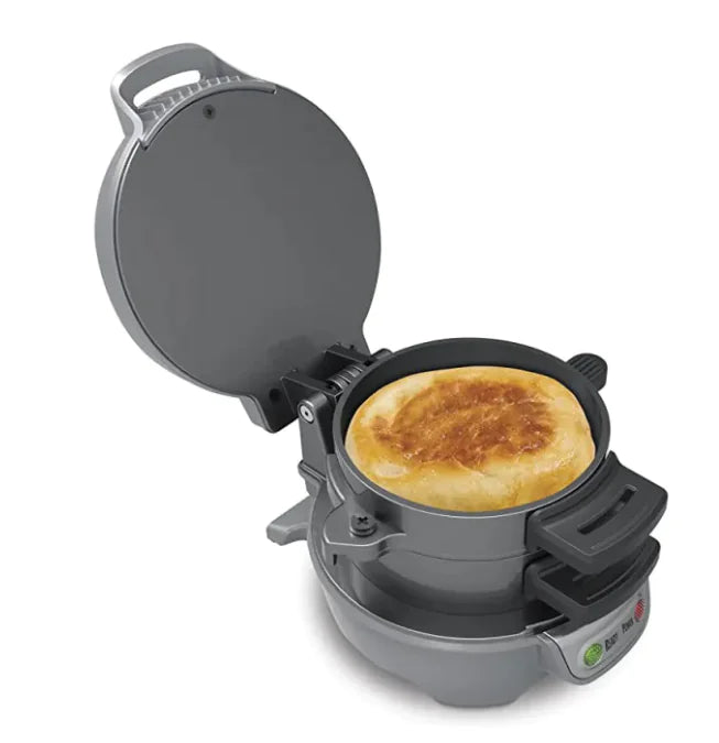 Gray waffle maker with a cooked waffle inside on a white background