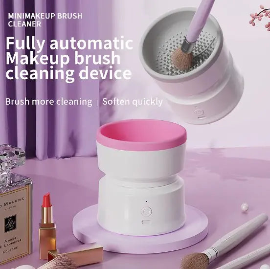 Makeup brush cleaning device with pink and white design on a light purple background.