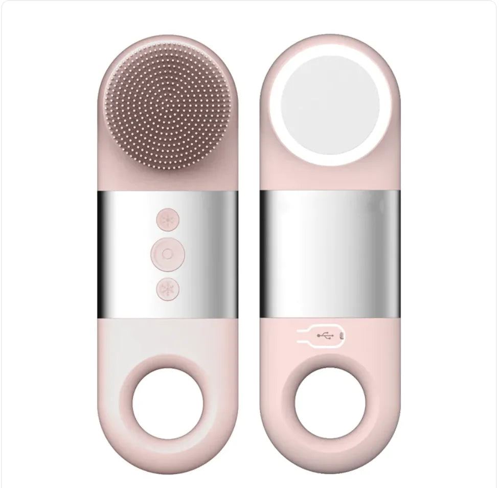 Pink and silver electronic device with a round brush head on a white background