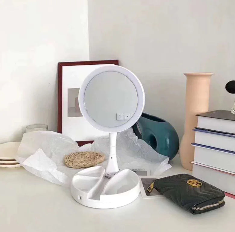 White vanity mirror on a desk with books and a wallet in the background