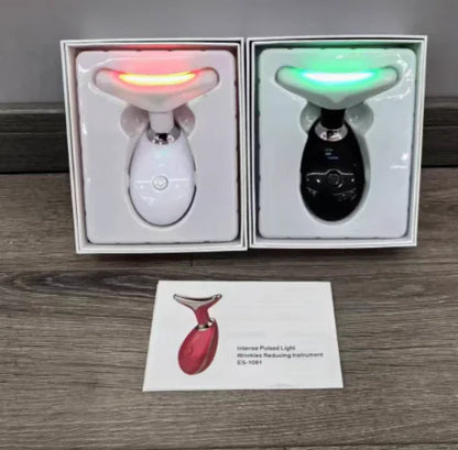 Two electronic devices in boxes with a business card on a wooden surface