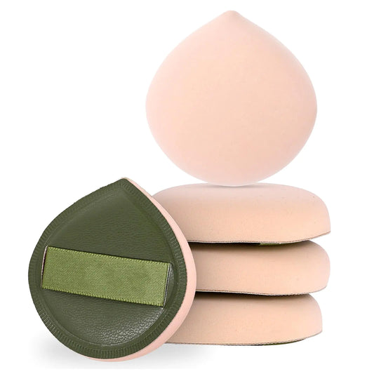 Set of makeup sponges with a green case on a white background