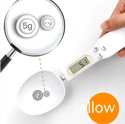 Digital kitchen scale with a hand holding it, displaying weight measurement.