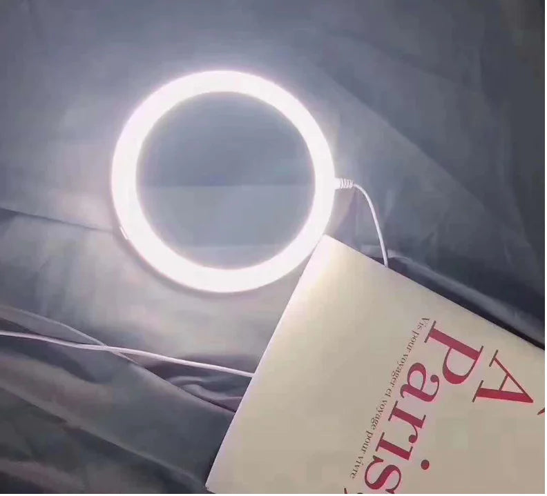 Ring light on a book with 'Paris' text against a dark background