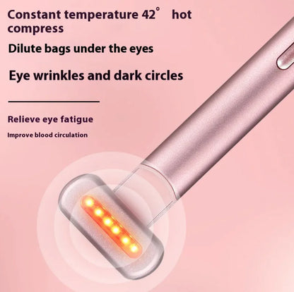 Pink handheld device with LED lights on a pink background, used for eye care.