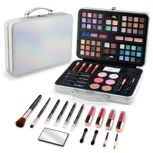 Makeup set with brushes, lipsticks, and palettes in a silver case on a white background