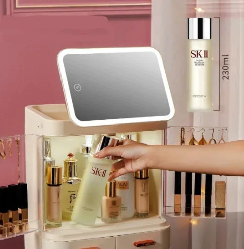 Hand reaching for skincare products on a vanity with an illuminated mirror and SK-II bottle in the background.