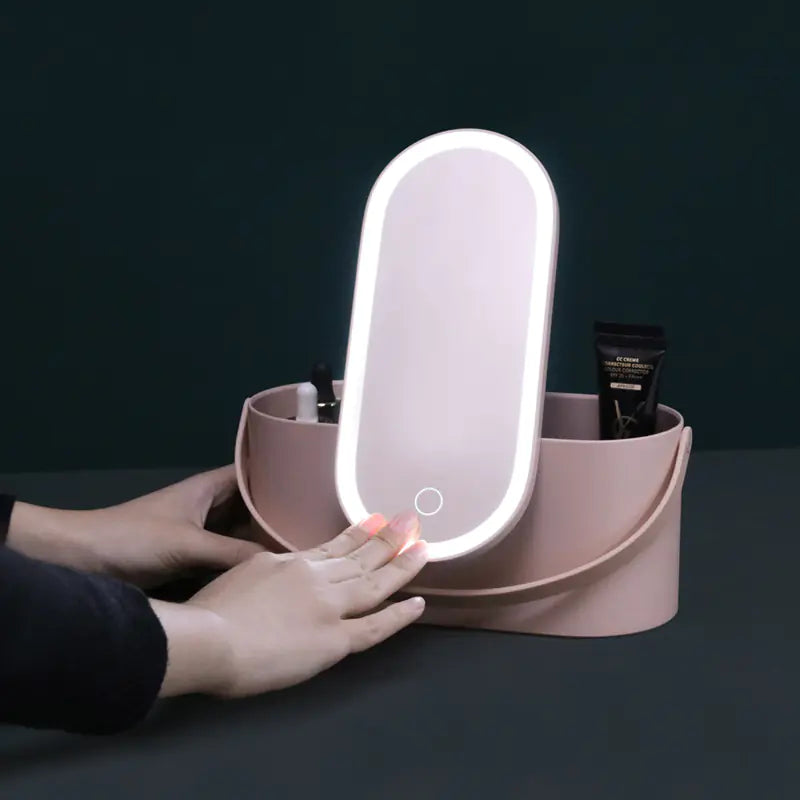 Pink makeup organizer with a light-up mirror on a dark background